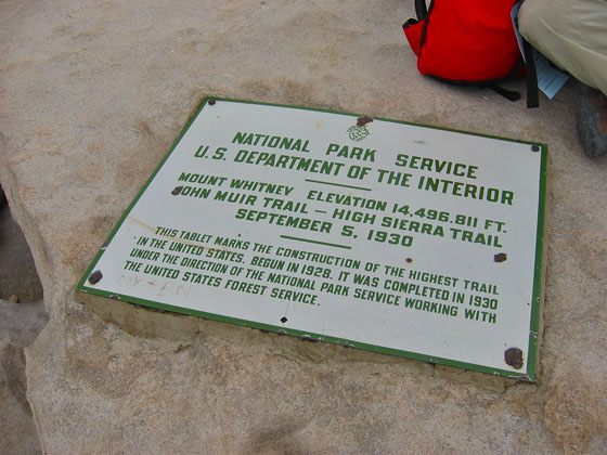 The summit plaque mentioning the former official altitude